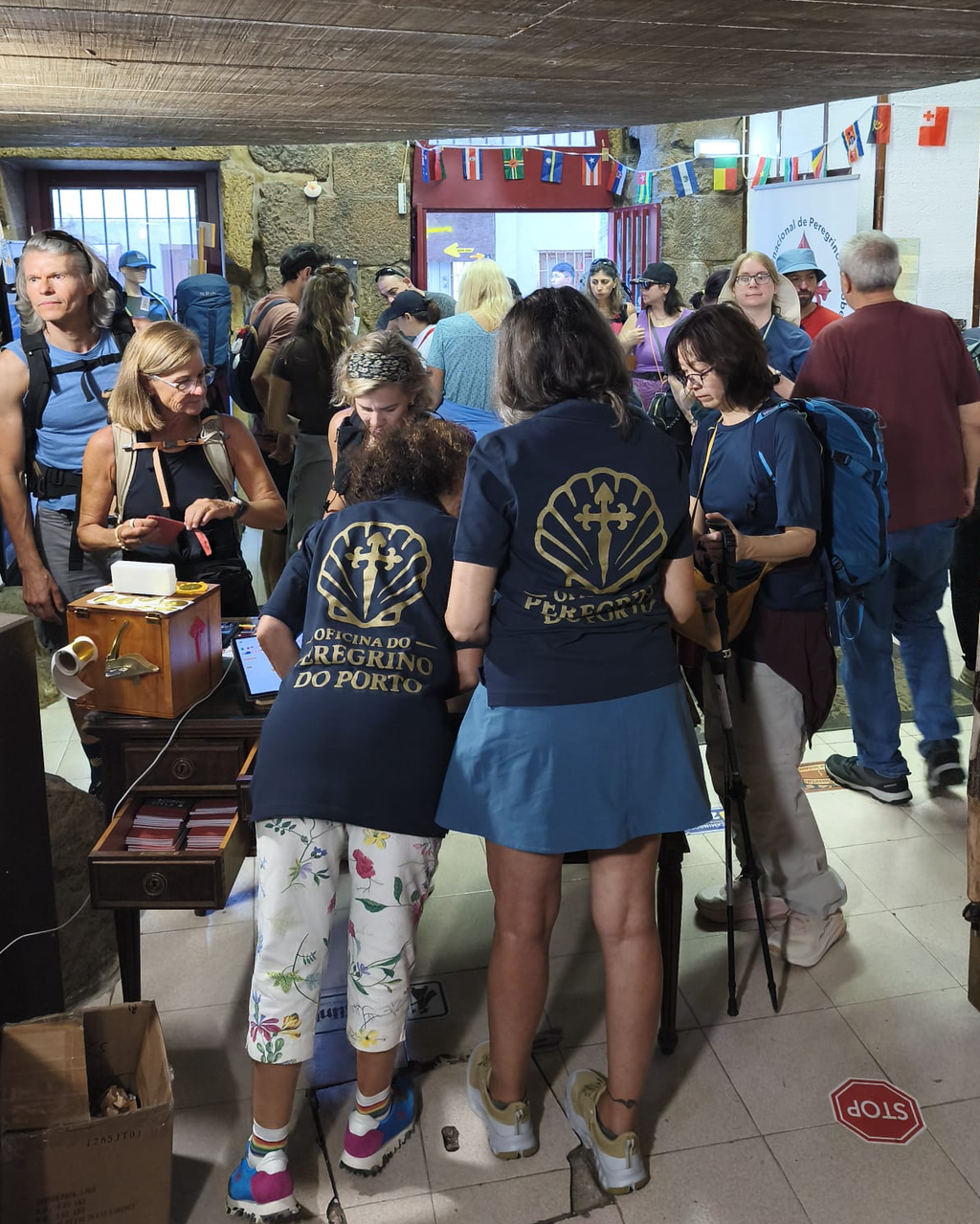 Volunteers at the Oficina do Peregrino in Porto in Camino Care polo shirts